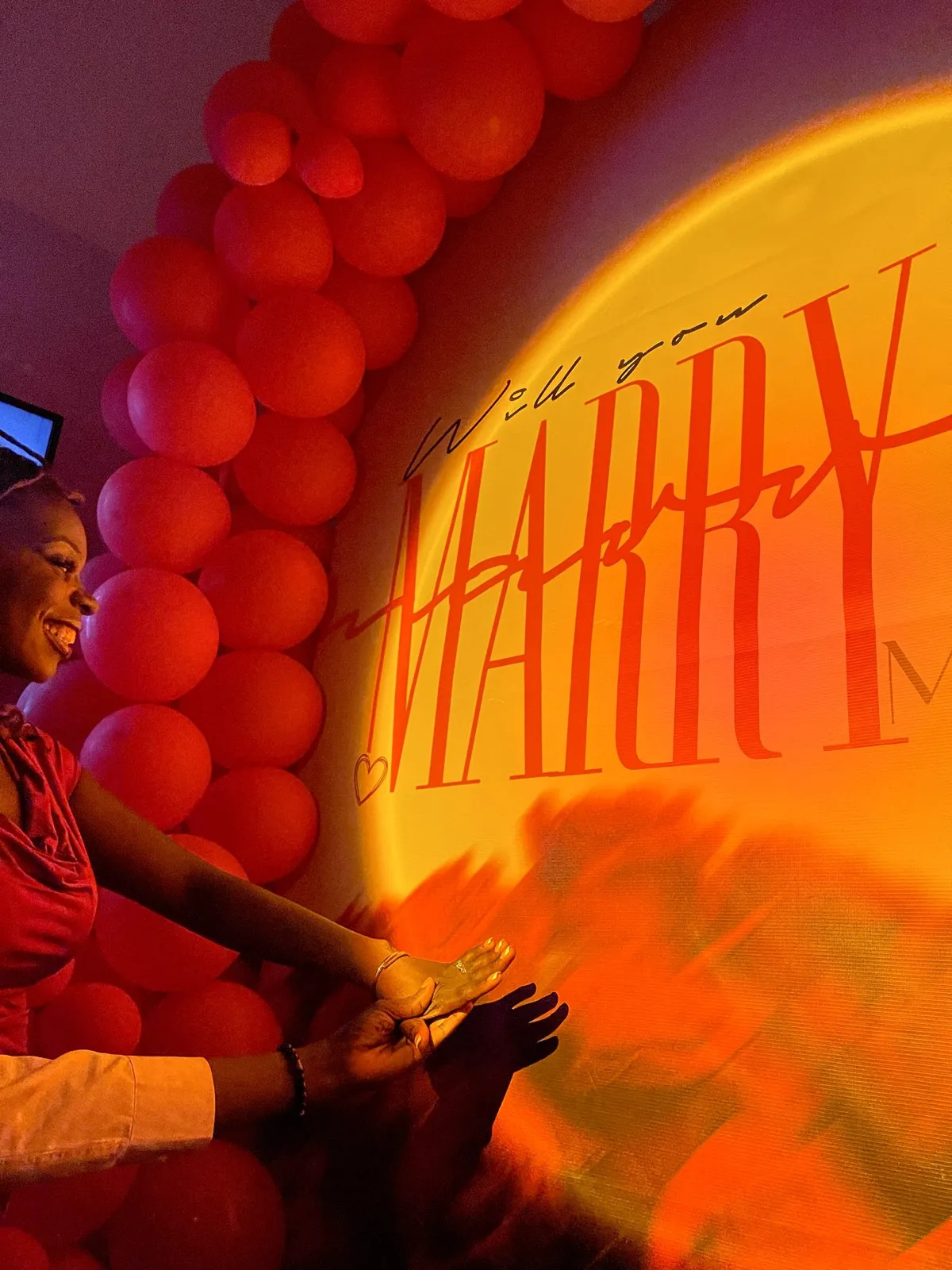 Mary-Ann smiling at the proposal wall