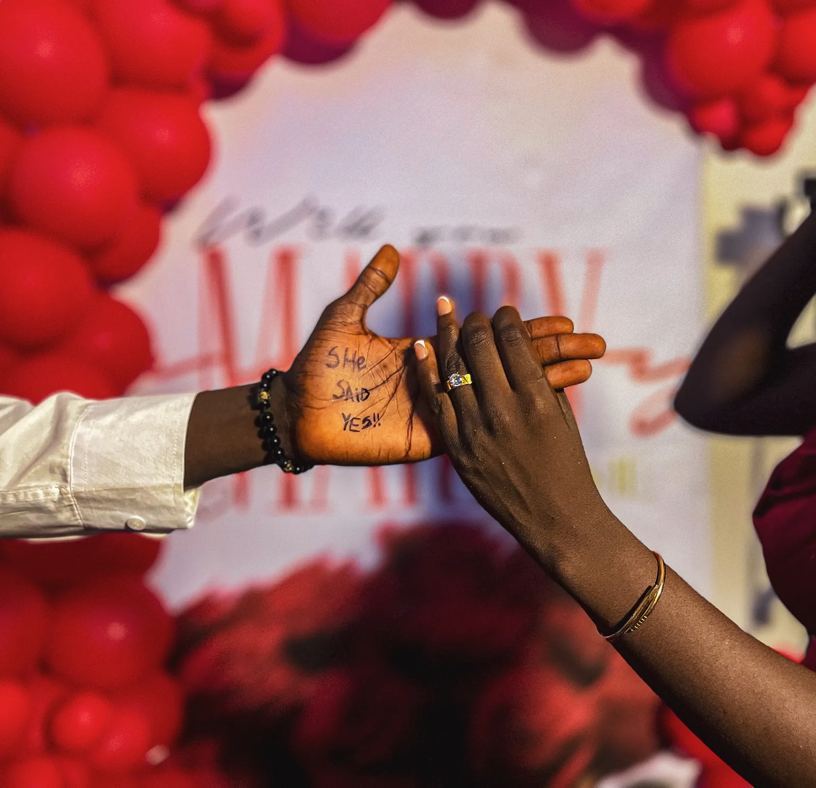 His palm reads She said yes, her ring hand beside it